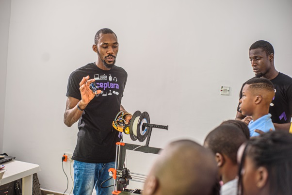 Picture of five (5) girls interacting with an iPad